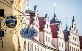 Sign of the Platzl Hotel & the Wirtshaus Ayinger am Platzl in front of facades in Munich's old town.