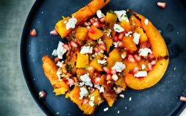 Tasty pumpkin dish on a dark blue plate.