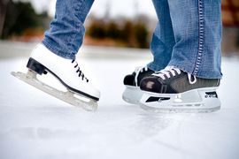 White and black ice skates of a couple.