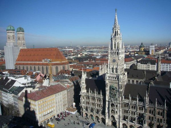 The historic city center shines under clear blue skies, showcasing iconic Gothic and Renaissance architecture.