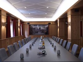 A long event table in a conference hall ideal for meetings and other events.