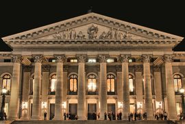 Munich's Bavarian State Opera glows under the night sky.