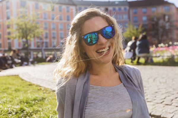 Happy girl on a sunny day at the Gärtnerplatz near Marias Platzl Hotel
