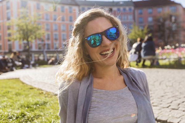 Glückliche Frau auf dem Gärtnerplatz in München.