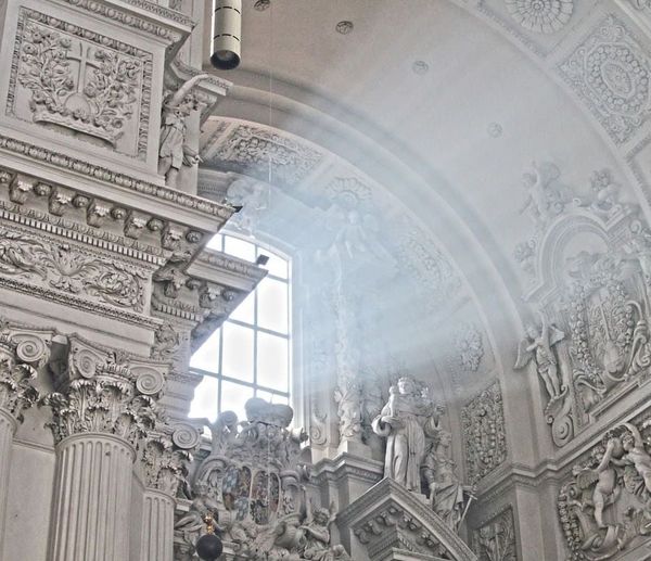 Interior view of the white architecture of the Theatinerkirche in Munich.
