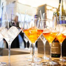 Several aperitif glasses set with ice cubes.