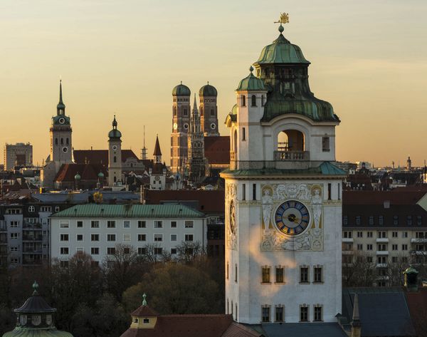 Overview of the roofs of Munich with the different church towers in the sunset 