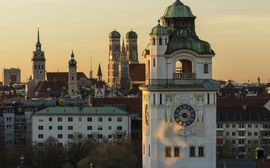 Overview of the roofs of Munich with the different church towers in the sunset
